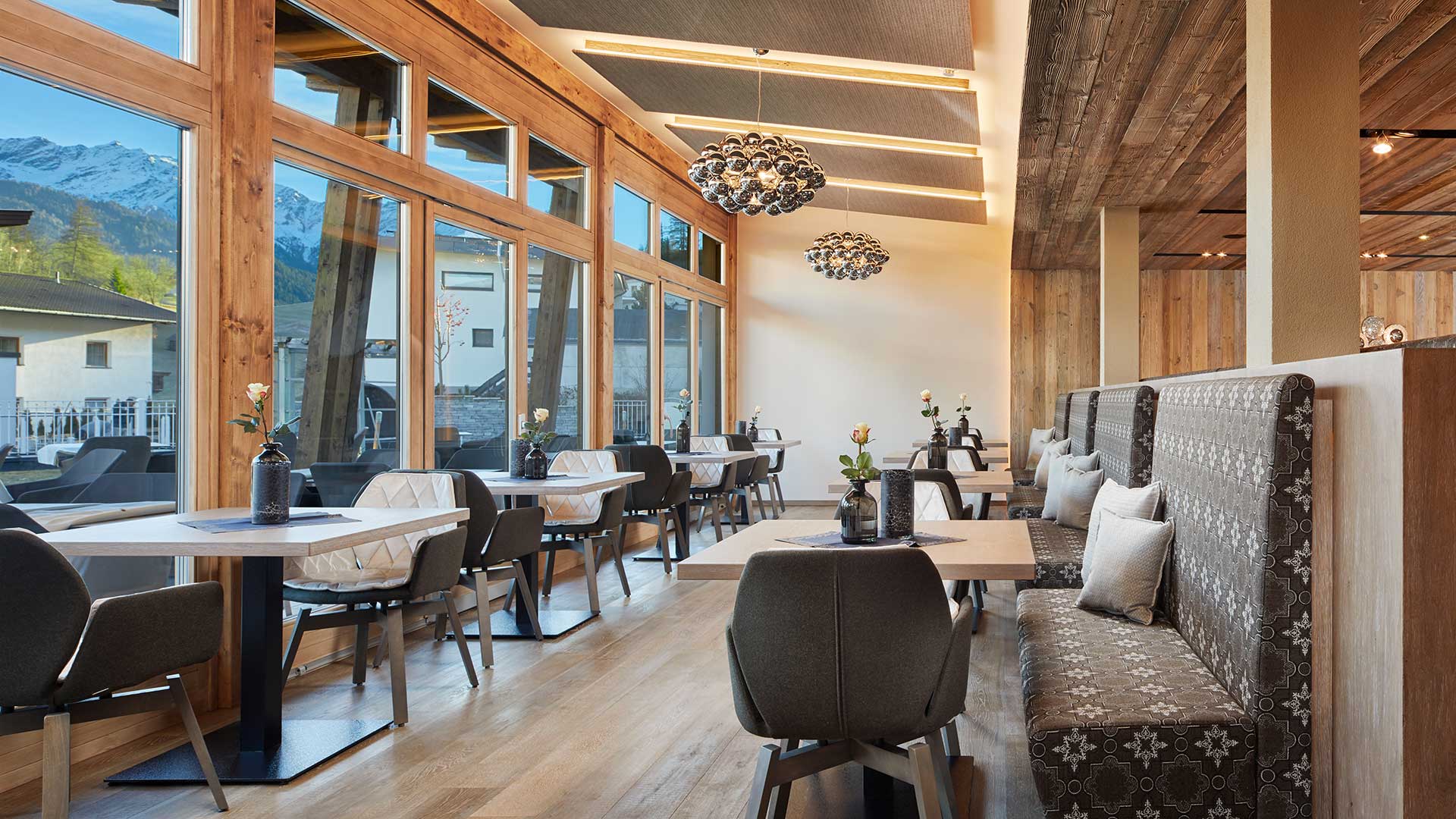 Bar mit großer Fensterfront im Hotel Goies in Tirol